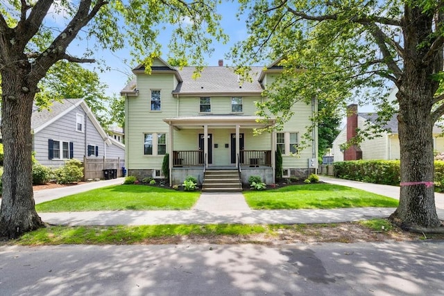 111-113 Pleasant St, Milton, MA 02186 - view of front of property with a porch, a front yard, and a chimney