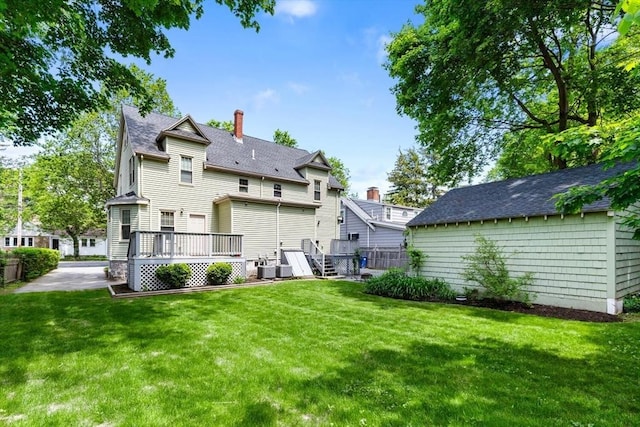 111-113 Pleasant St, Milton, MA 02186 - back of property with a wooden deck, a yard, a chimney, and a shingled roof