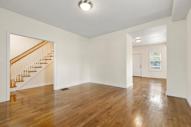 111-113 Pleasant St, Milton, MA 02186 - empty room with stairs and wood finished floors