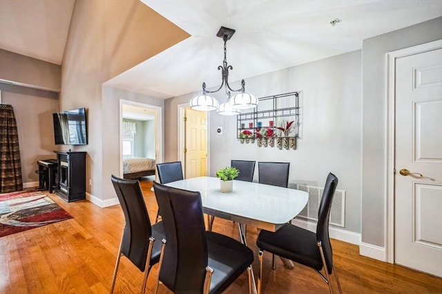 dining space with a notable chandelier and wood-type flooring