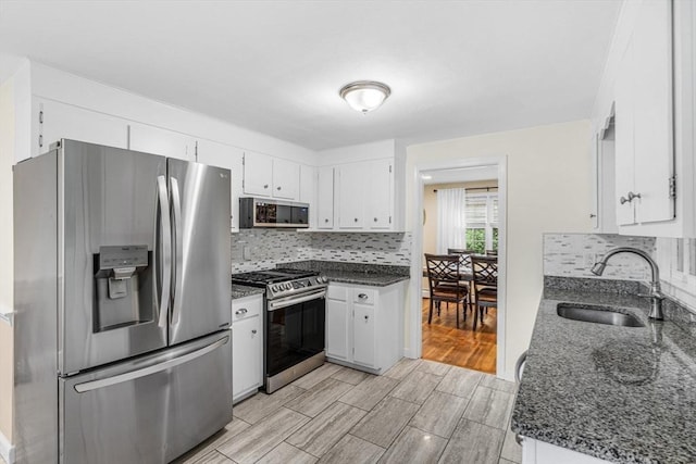 23 Cherokee Rd, Acton, MA 01720 - kitchen featuring appliances with stainless steel finishes, a sink, backsplash, white cabinetry, and dark stone counters