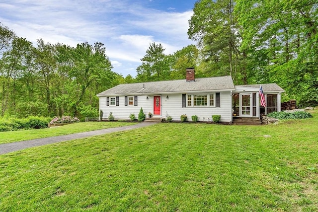 23 Cherokee Rd, Acton, MA 01720 - single story home with a sunroom, a chimney, a front yard, and entry steps