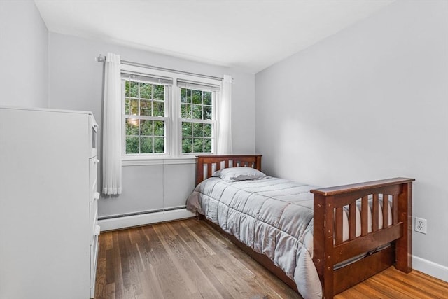 23 Cherokee Rd, Acton, MA 01720 - bedroom featuring a baseboard radiator and wood finished floors