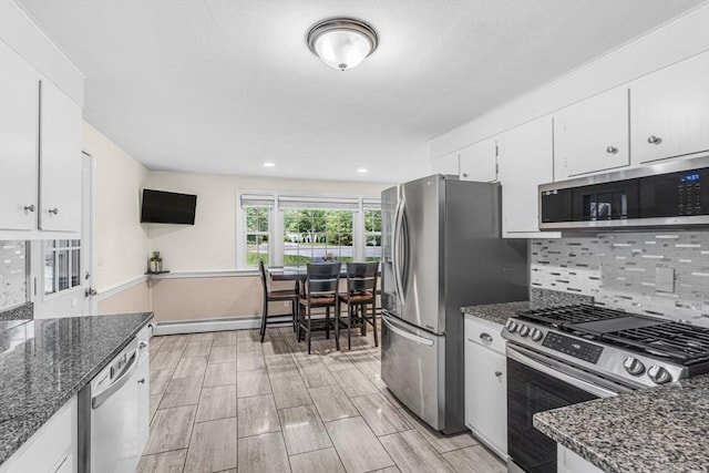 23 Cherokee Rd, Acton, MA 01720 - kitchen featuring stainless steel appliances, white cabinetry, dark stone counters, tasteful backsplash, and recessed lighting
