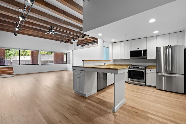 33 Sleeper St Unit 104, Boston, MA 02210 - kitchen featuring stainless steel appliances, recessed lighting, light wood-style floors, open floor plan, and baseboards