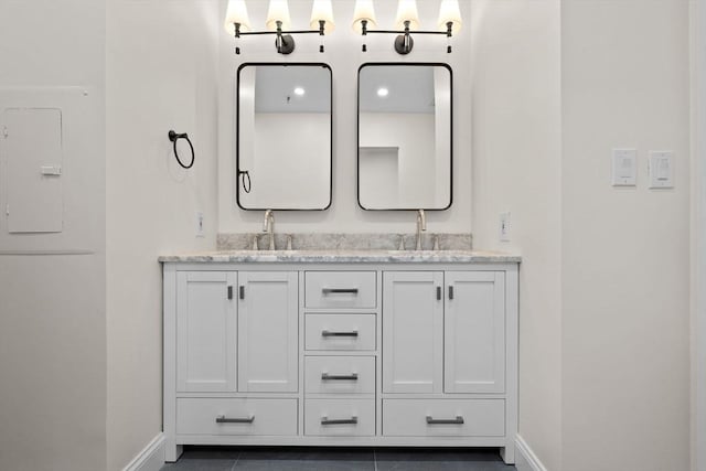 33 Sleeper St Unit 104, Boston, MA 02210 - full bathroom with double vanity, baseboards, and electric panel