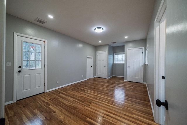 foyer entrance featuring wood finished floors, baseboards, and recessed lighting