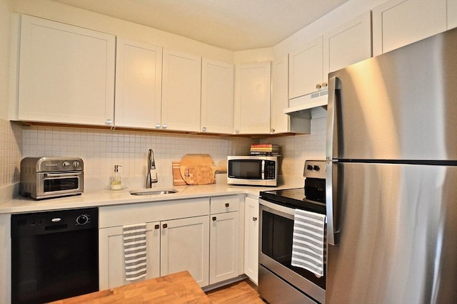 151 Bittersweet Ln Unit 208, Randolph, MA 02368 - kitchen with stainless steel appliances, light countertops, under cabinet range hood, and white cabinets