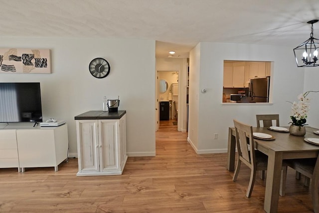 151 Bittersweet Ln Unit 208, Randolph, MA 02368 - dining area featuring a chandelier and light wood-style flooring