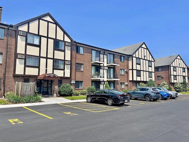 151 Bittersweet Ln Unit 208, Randolph, MA 02368 - view of property featuring uncovered parking