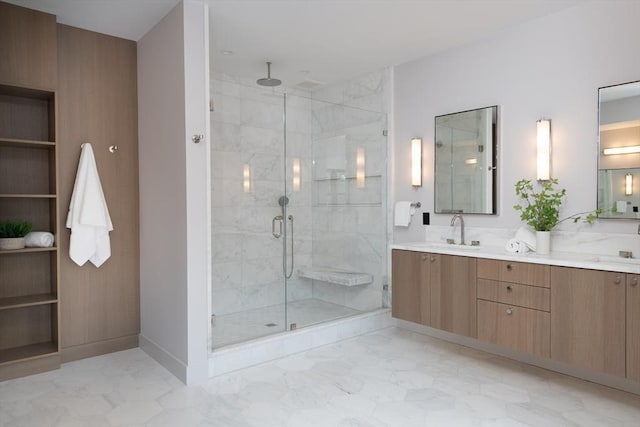 bathroom featuring a shower with door and vanity