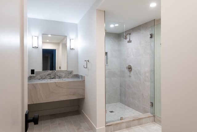 bathroom featuring vanity and a shower with shower door