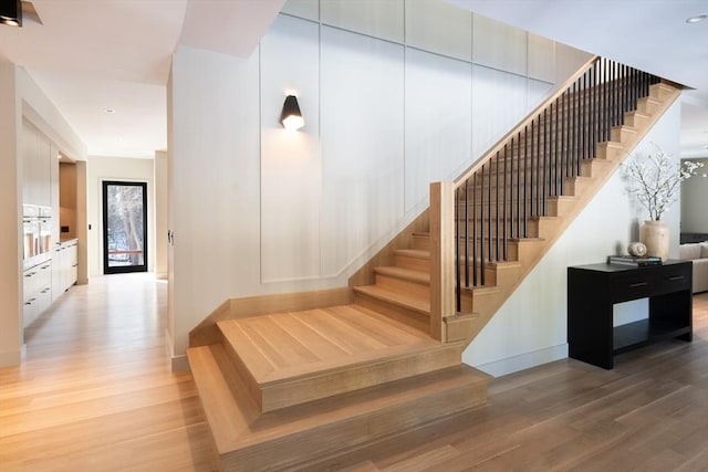 staircase with wood-type flooring