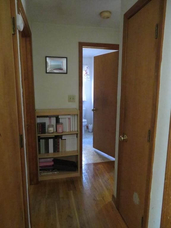 corridor featuring wood finished floors