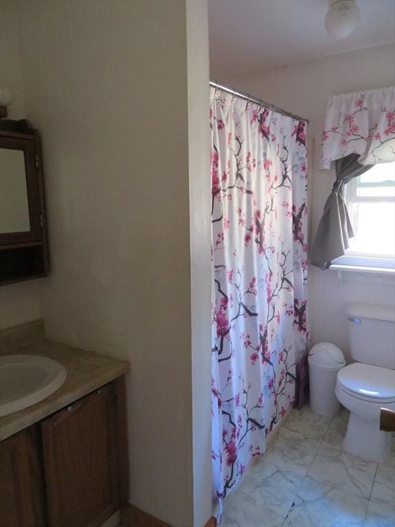 full bath featuring toilet, marble finish floor, a shower with curtain, and vanity