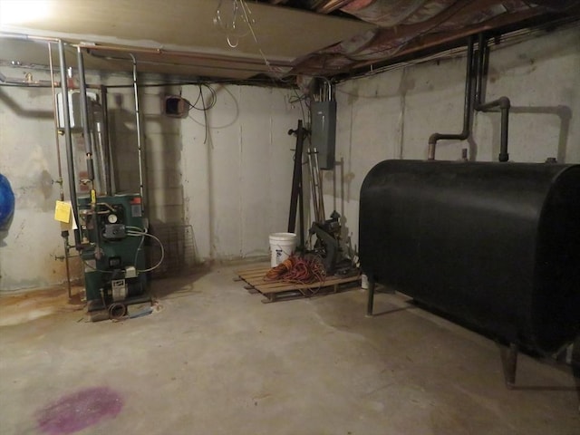 unfinished below grade area featuring a heating unit, electric panel, and heating fuel