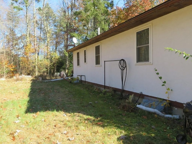 view of home's exterior featuring a yard and stucco siding