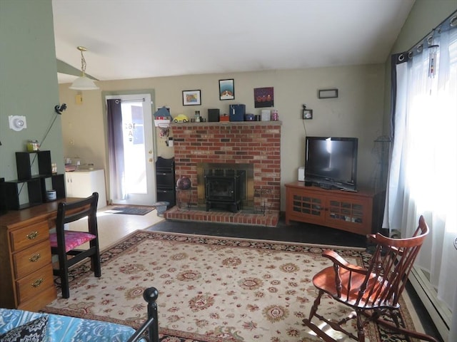 living area with a baseboard radiator, a wood stove, and vaulted ceiling