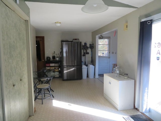 kitchen with light floors and freestanding refrigerator