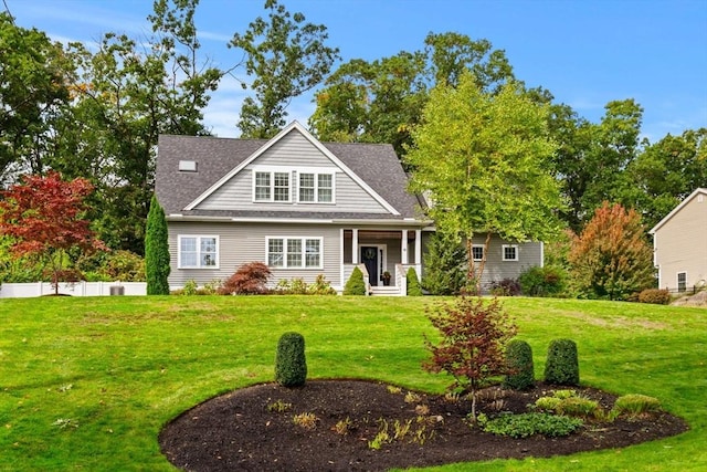 view of front facade featuring a front lawn and roof with shingles