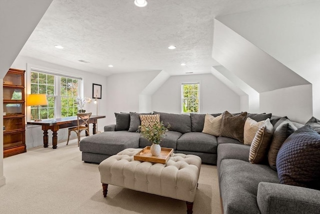 living area with light carpet, recessed lighting, a textured ceiling, and lofted ceiling