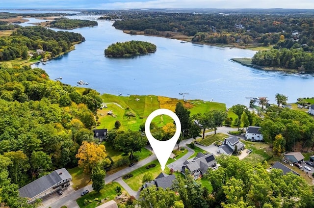 drone / aerial view featuring a forest view and a water view