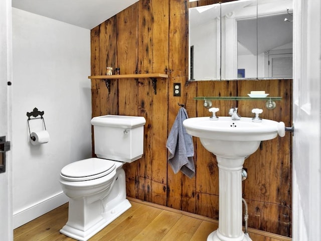 bathroom with wood-type flooring and toilet