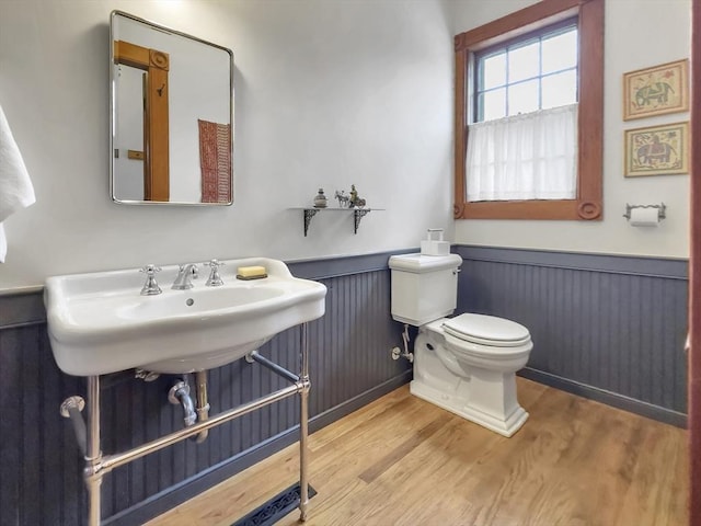 bathroom with hardwood / wood-style flooring, sink, and toilet