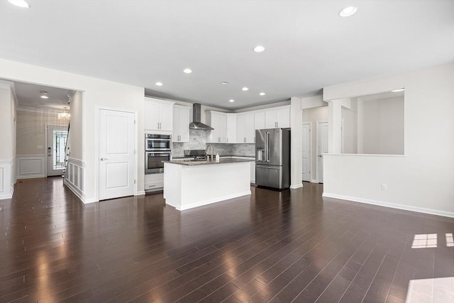 184 Stonehaven Dr, Weymouth, MA 02190 - kitchen with appliances with stainless steel finishes, wall chimney exhaust hood, white cabinets, dark countertops, and tasteful backsplash