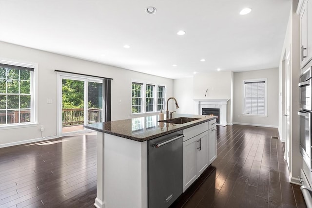 184 Stonehaven Dr, Weymouth, MA 02190 - kitchen with dishwasher, open floor plan, a sink, dark wood finished floors, and baseboards