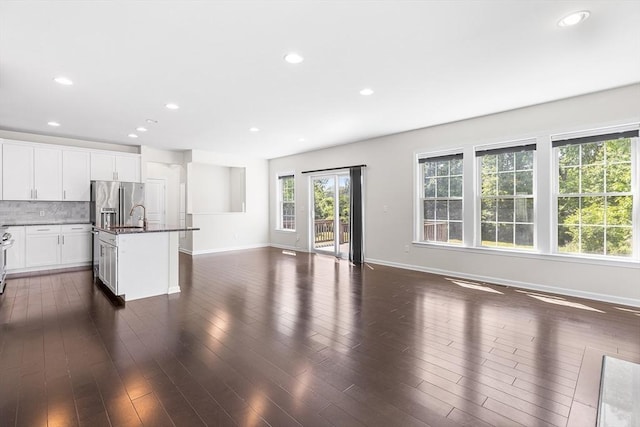 184 Stonehaven Dr, Weymouth, MA 02190 - unfurnished living room featuring baseboards, recessed lighting, dark wood finished floors, and a sink