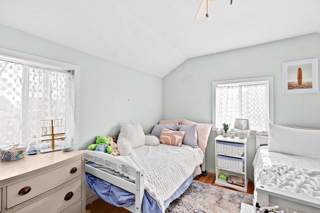 bedroom featuring vaulted ceiling, wood finished floors, and a ceiling fan