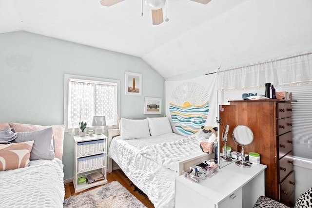 bedroom featuring ceiling fan, vaulted ceiling, and wood finished floors