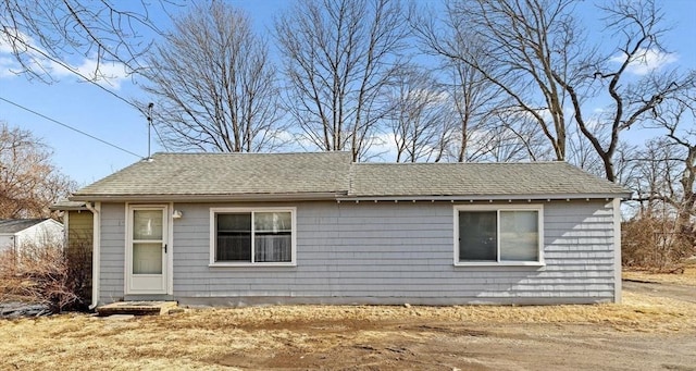 exterior space with roof with shingles