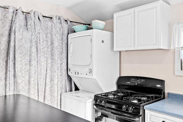 kitchen featuring lofted ceiling, black range with gas cooktop, and white cabinets