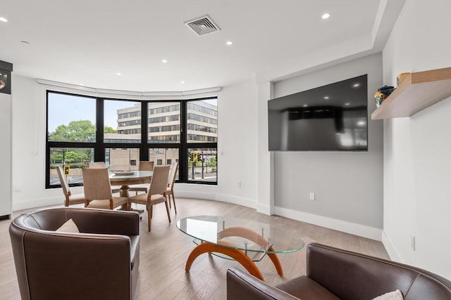 69 Walnut St Unit 4, Brookline, MA 02445 - living area featuring healthy amount of natural light, recessed lighting, wood finished floors, and baseboards
