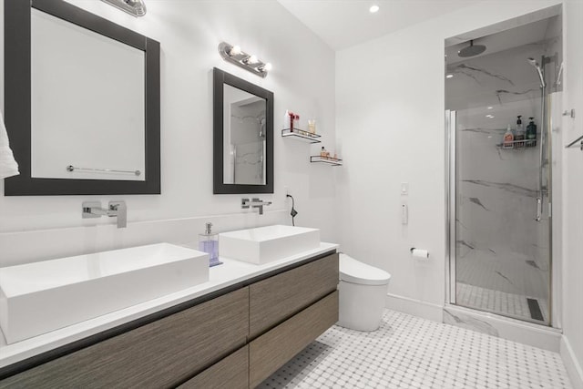 69 Walnut St Unit 4, Brookline, MA 02445 - bathroom featuring a marble finish shower, toilet, double vanity, baseboards, and recessed lighting