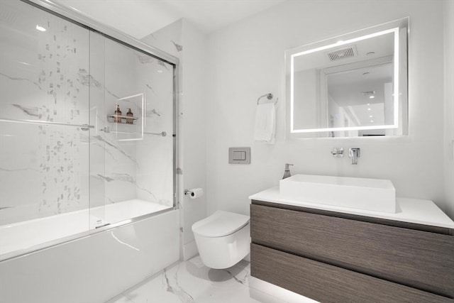 69 Walnut St Unit 4, Brookline, MA 02445 - bathroom with marble finish flooring, toilet, vanity, and enclosed tub / shower combo