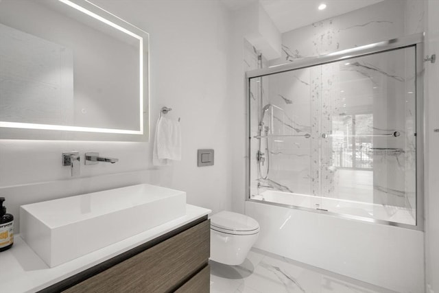 69 Walnut St Unit 4, Brookline, MA 02445 - bathroom with marble finish floors, toilet, vanity, and combined bath / shower with glass door