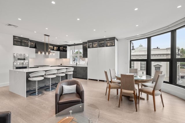 69 Walnut St Unit 4, Brookline, MA 02445 - dining space with light wood finished floors, recessed lighting, and baseboards