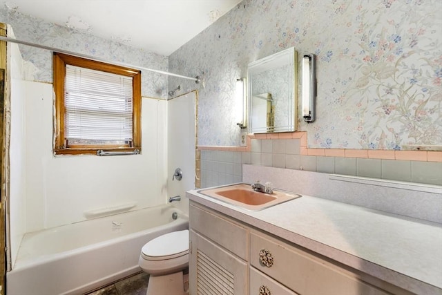 full bathroom with  shower combination, vanity, toilet, and wallpapered walls