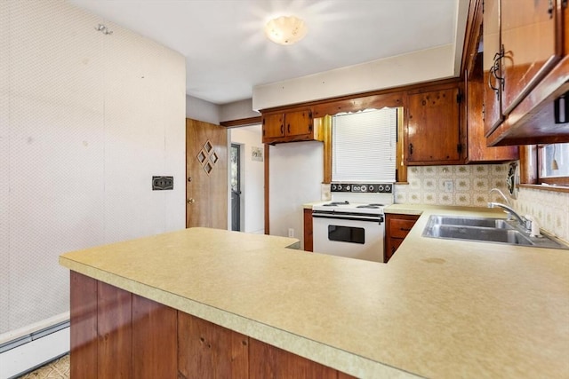 kitchen with electric range, decorative backsplash, a baseboard radiator, light countertops, and a sink