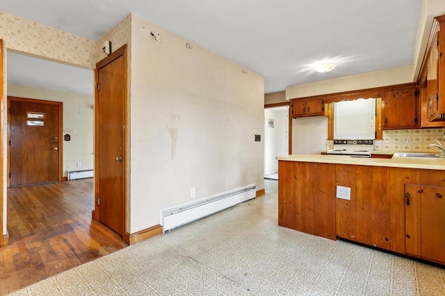 kitchen featuring brown cabinets, a baseboard radiator, and light countertops