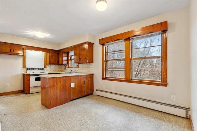 kitchen featuring white range with electric stovetop, brown cabinetry, a peninsula, light floors, and a baseboard heating unit