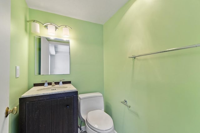 bathroom with toilet and vanity