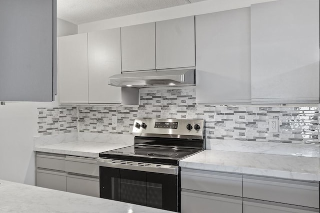 kitchen with stainless steel electric range oven, under cabinet range hood, decorative backsplash, and light stone counters