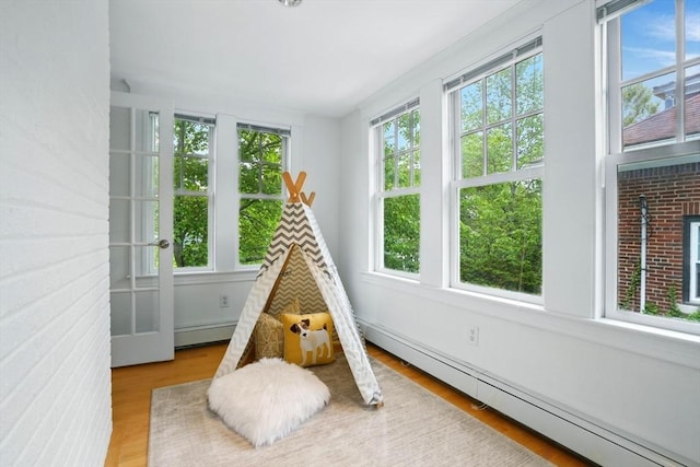 11 Longfellow Rd, Cambridge, MA 02138 - recreation room featuring a baseboard radiator and wood finished floors