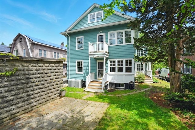 11 Longfellow Rd, Cambridge, MA 02138 - back of house featuring a balcony, a yard, central AC unit, and a patio area