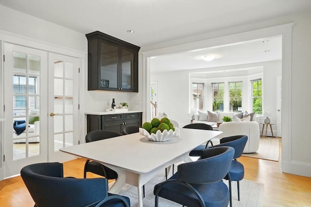 11 Longfellow Rd, Cambridge, MA 02138 - dining room with french doors, light wood-type flooring, and bar