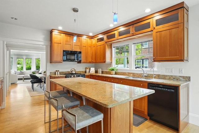 11 Longfellow Rd, Cambridge, MA 02138 - kitchen with black appliances, a sink, light wood-type flooring, plenty of natural light, and recessed lighting